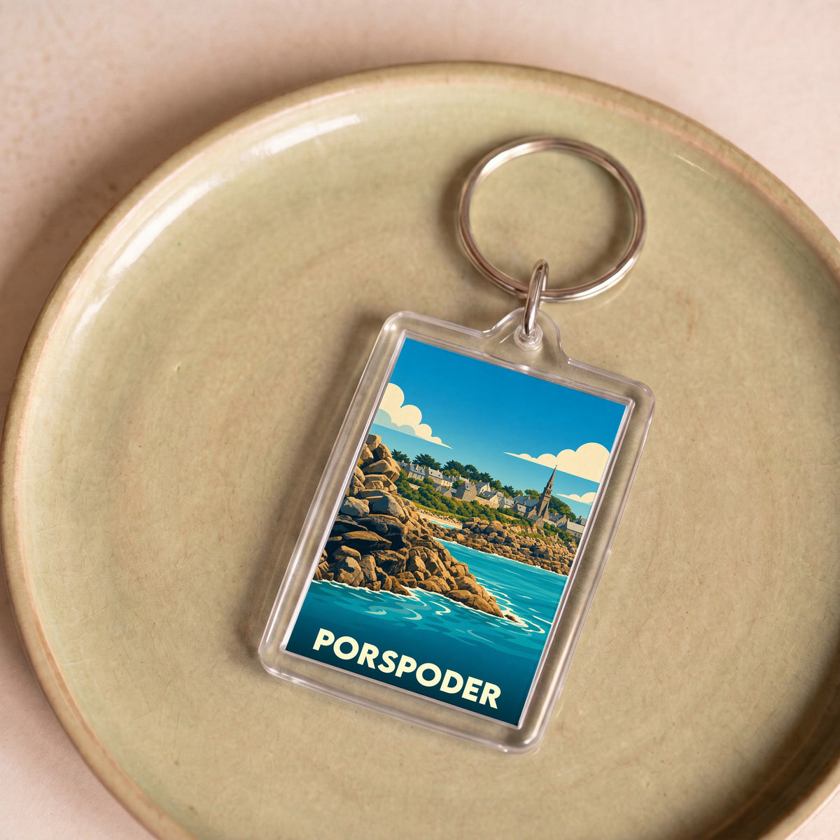 Porte-clés souvenir de la ville de Porspoder avec une illustration stylisée de son paysage côtier.