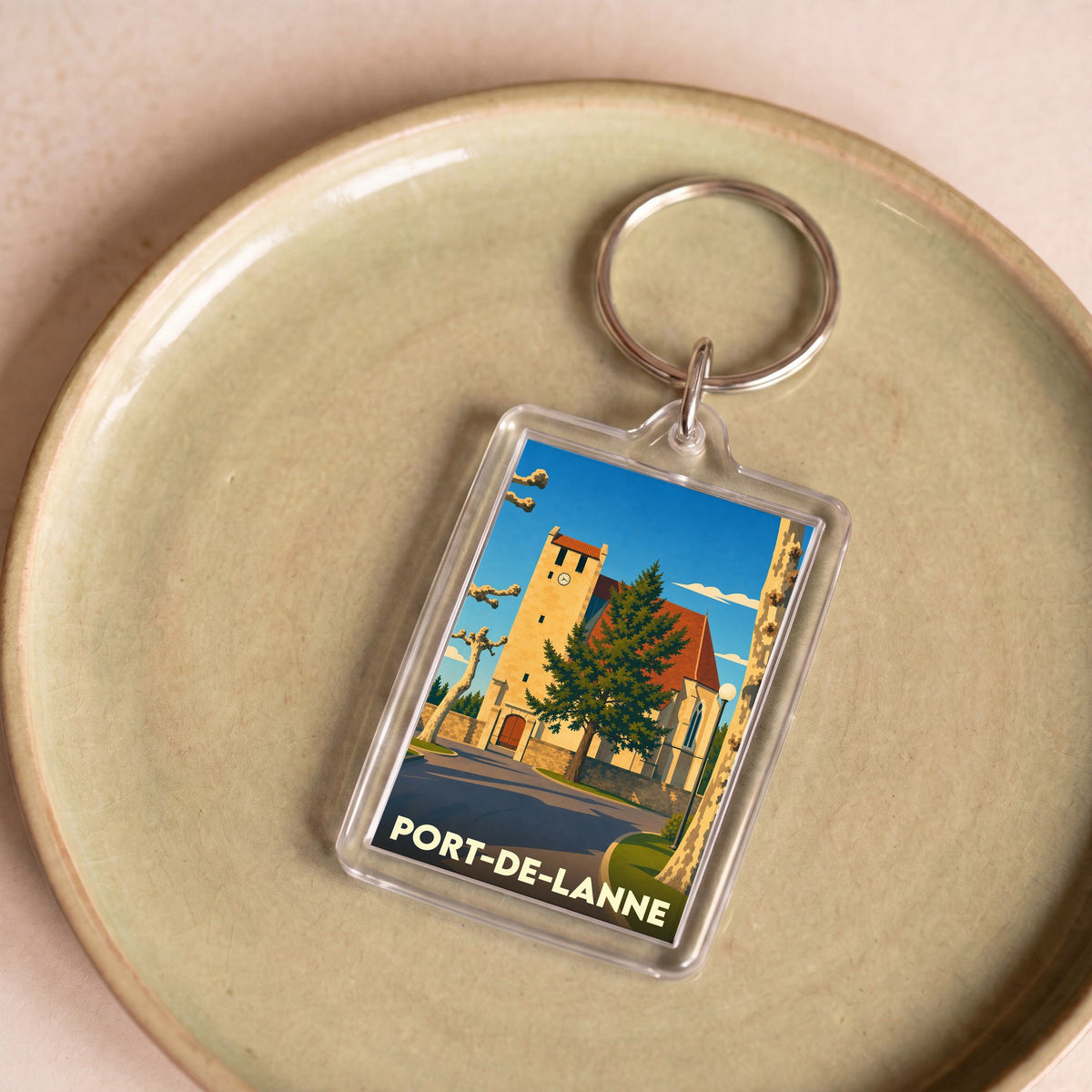 Porte-clés souvenir de la ville de Port-de-Lanne avec une illustration stylisée de son église.