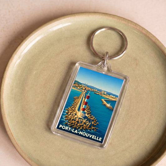 Porte-clés souvenir de la ville de Port-la-Nouvelle avec une illustration stylisée d'un phare.