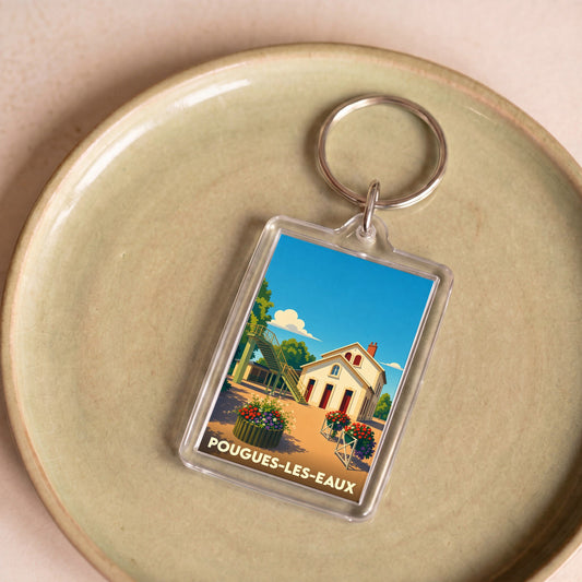 Porte-clés souvenir de la ville de Pougues-les-Eaux avec une illustration stylisée.