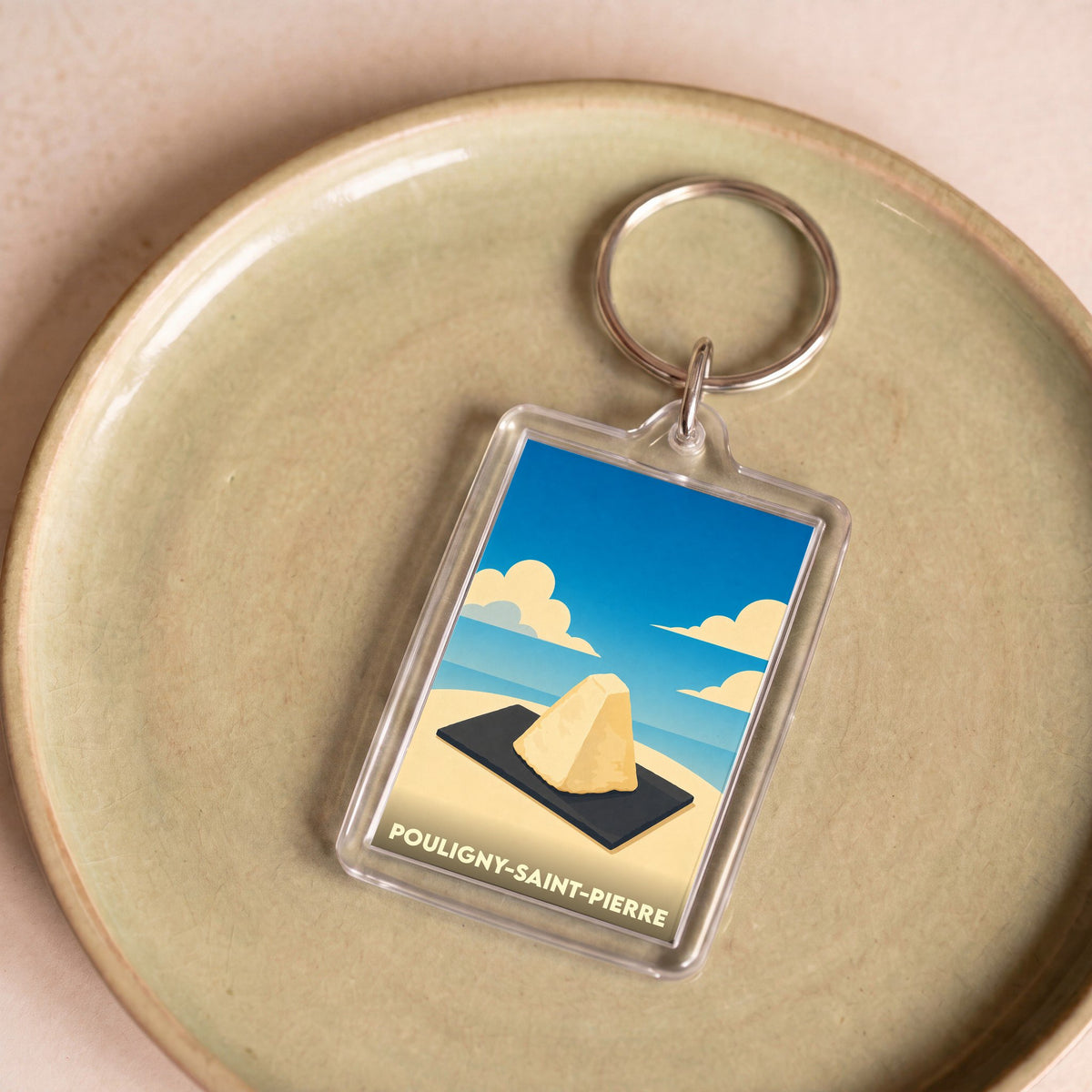 Porte-clés souvenir de la ville de Pouligny-Saint-Pierre avec une illustration stylisée de son fromage emblématique.