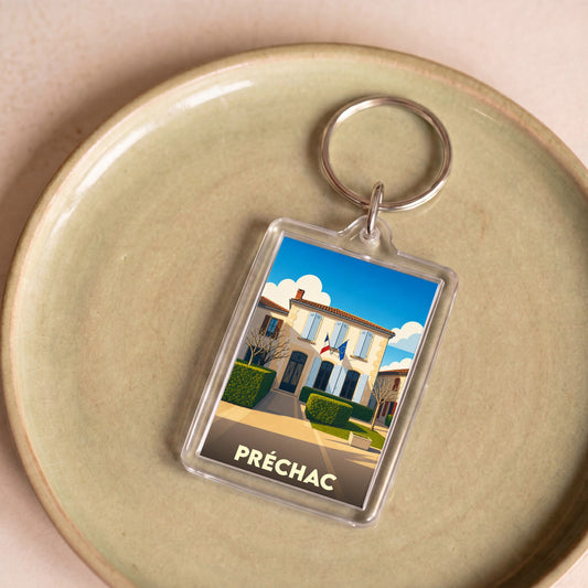 Porte-clés souvenir de la ville de Préchac avec une illustration stylisée.