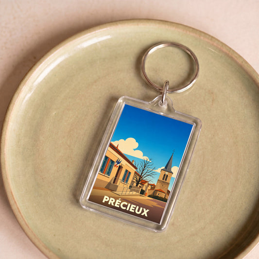 Porte-clés souvenir de la ville de Précieux avec une illustration stylisée.