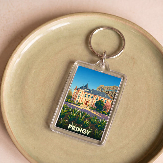 Porte-clés souvenir de la ville de Pringy avec une illustration stylisée d'un château et de fleurs.