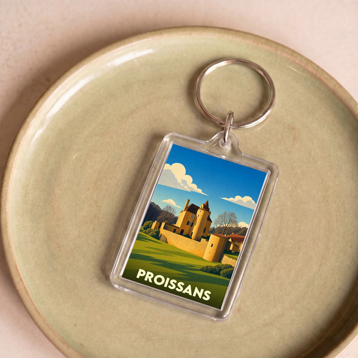 Porte-clés souvenir de la ville de Proissans avec une illustration stylisée de son château.