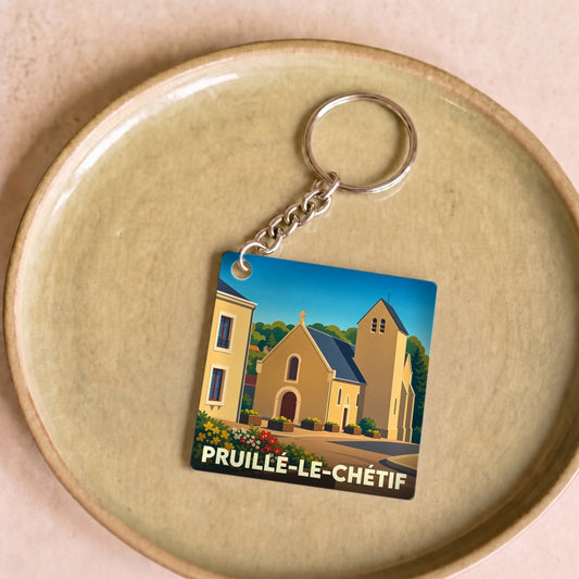 Porte-clés souvenir de la ville de Pruillé-le-Chétif avec une illustration stylisée de son église.