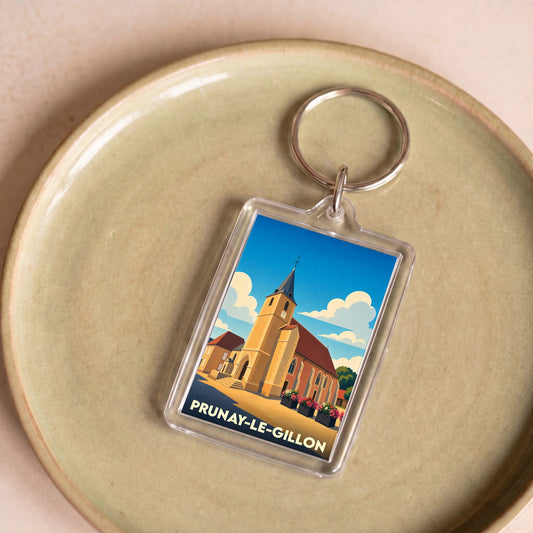 Porte-clés souvenir de la ville de Prunay-le-Gillon avec une illustration stylisée de son église.