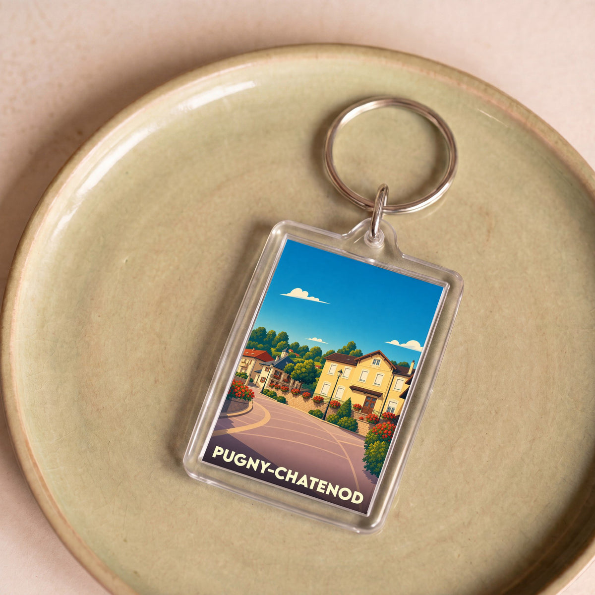 Porte-clés souvenir de la ville de Pugny-Chatenod avec une illustration stylisée.