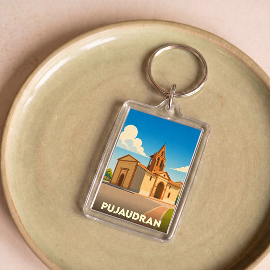 Porte-clés souvenir de la ville de Pujaudran avec une illustration stylisée de son église.