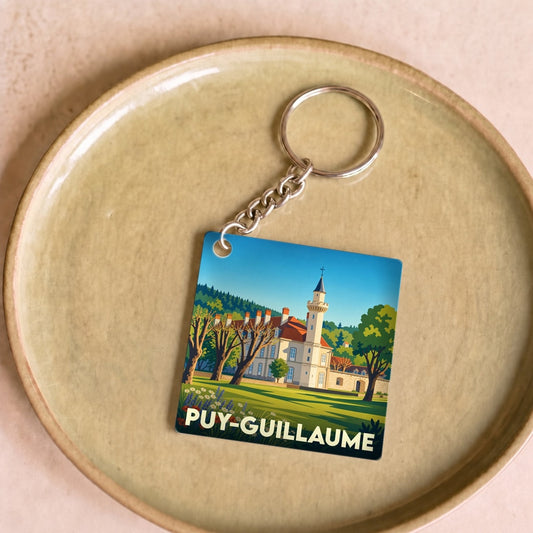 Porte-clés souvenir de la ville de Puy-Guillaume avec une illustration stylisée d'un château.