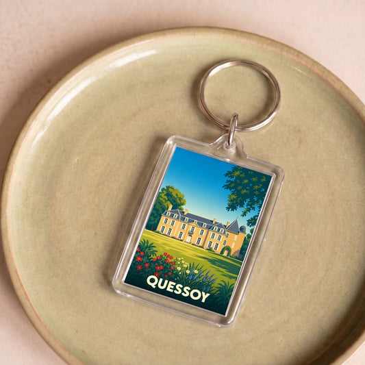 Porte-clés souvenir de la ville de Quessoy avec une illustration stylisée d'un château.