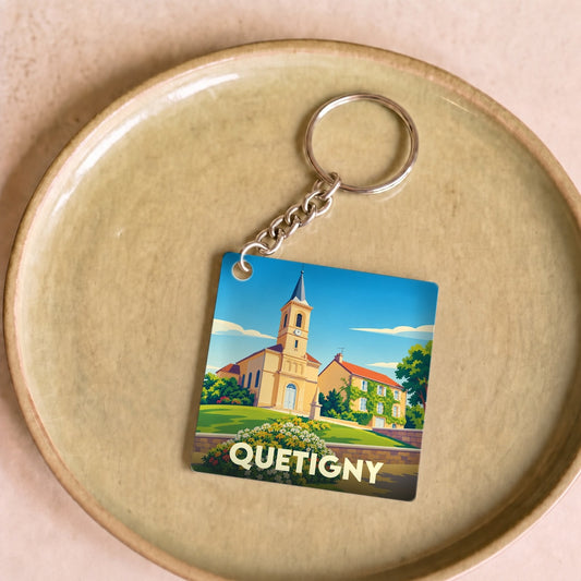 Porte-clés souvenir de la ville de Quetigny avec une illustration stylisée de son église.