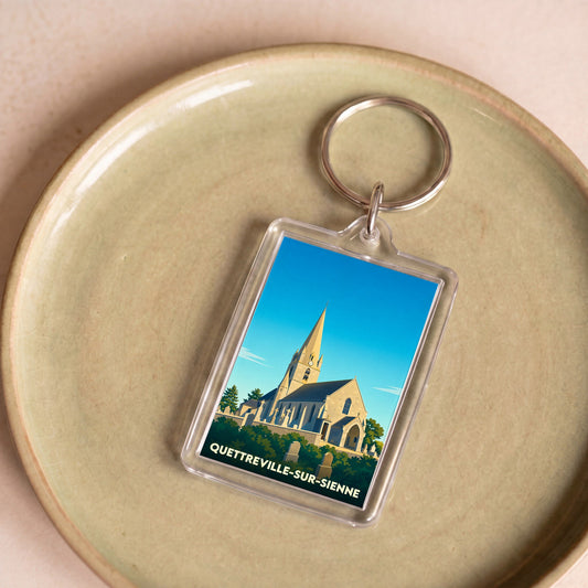 Porte-clés souvenir de la ville de Quettreville-sur-Sienne avec une illustration stylisée de son église.