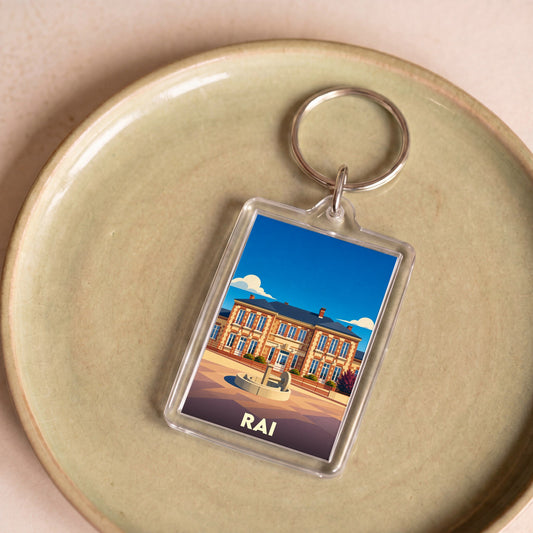 Porte-clés souvenir de la ville de Rai avec une illustration stylisée.