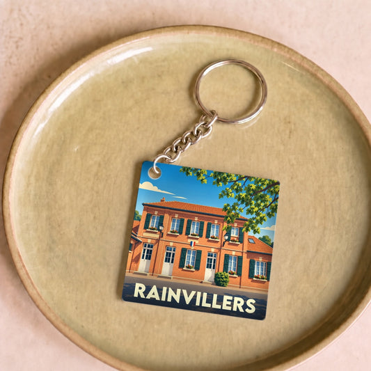 Porte-clés souvenir de la ville de Rainvillers avec une illustration stylisée de sa mairie.