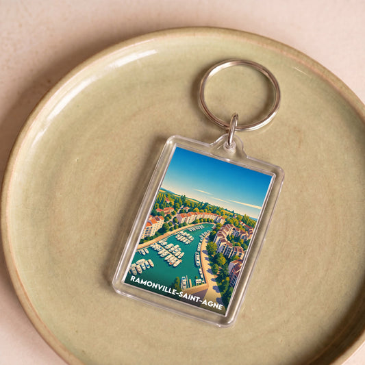 Porte-clés souvenir de la ville de Ramonville-Saint-Agne avec une illustration stylisée.