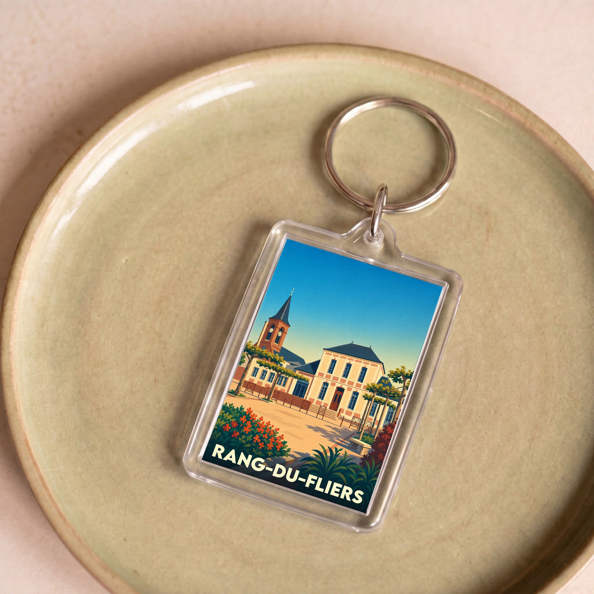 Porte-clés souvenir de la ville de Rang-du-Fliers avec une illustration stylisée.