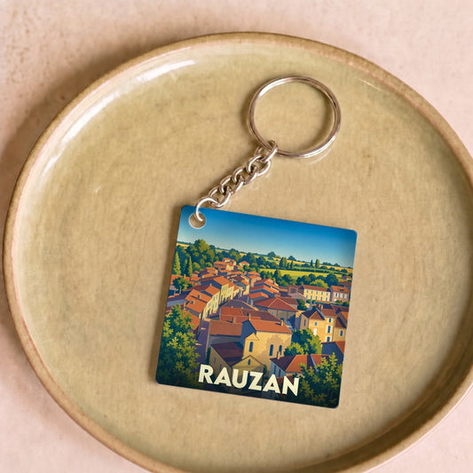 Porte-clés souvenir de la ville de Rauzan avec une illustration stylisée.