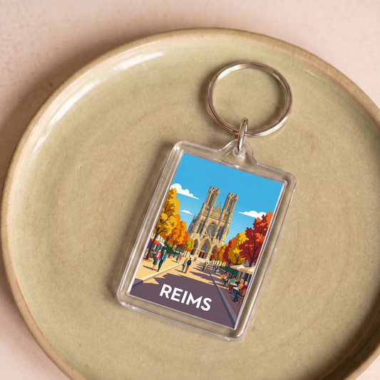 Porte-clés souvenir de la ville de Reims avec une illustration stylisée de sa cathédrale.