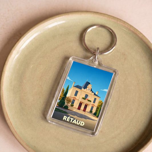 Porte-clés souvenir de la ville de Rétaud avec une illustration stylisée de sa mairie.