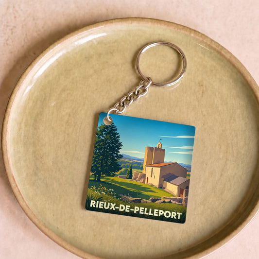 Porte-clés souvenir de la ville de Rieux-de-Pelleport avec une illustration stylisée.