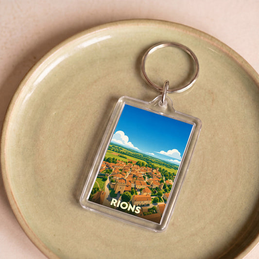 Porte-clés souvenir de la ville de Rions avec une illustration stylisée.