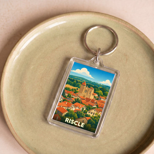 Porte-clés souvenir de la ville de Riscle avec une illustration stylisée.