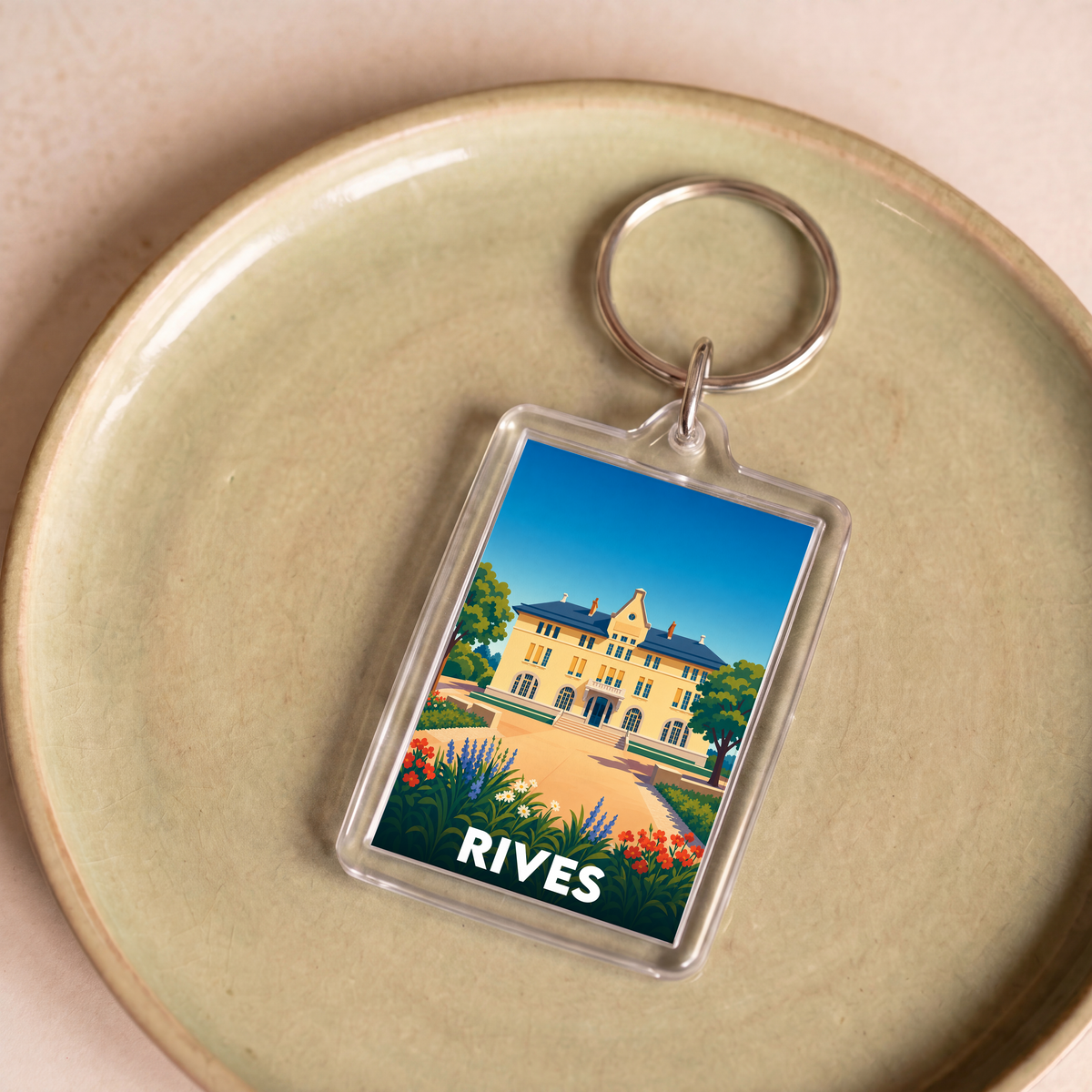 Porte-clés souvenir de la ville de Rives avec une illustration stylisée.