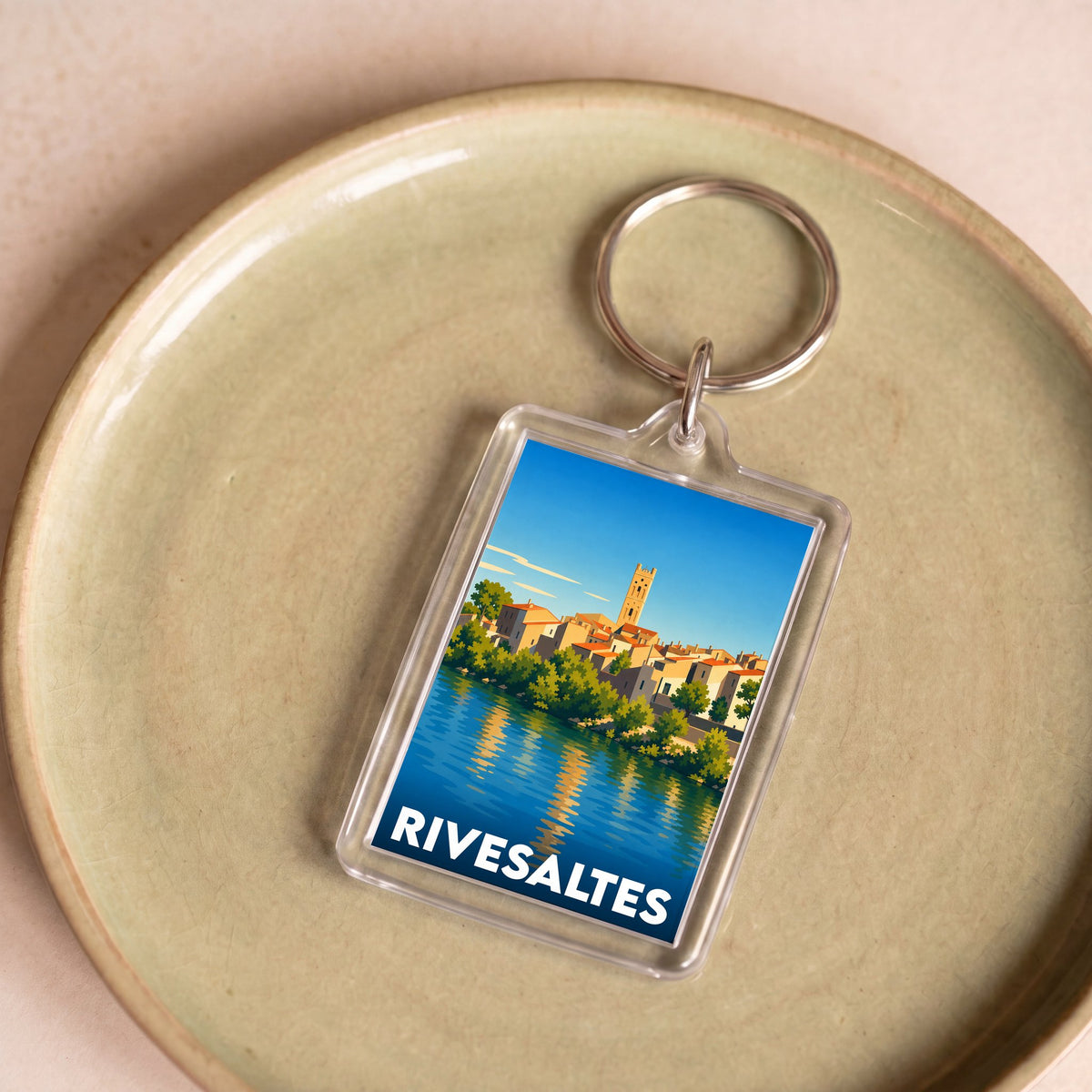 Porte-clés souvenir de la ville de Rivesaltes avec une illustration stylisée.
