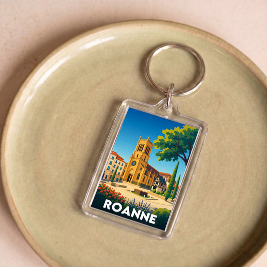 Porte-clés souvenir de la ville de Roanne avec une illustration stylisée.