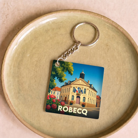 Porte-clés souvenir de la ville de Robecq avec une illustration stylisée de sa mairie.
