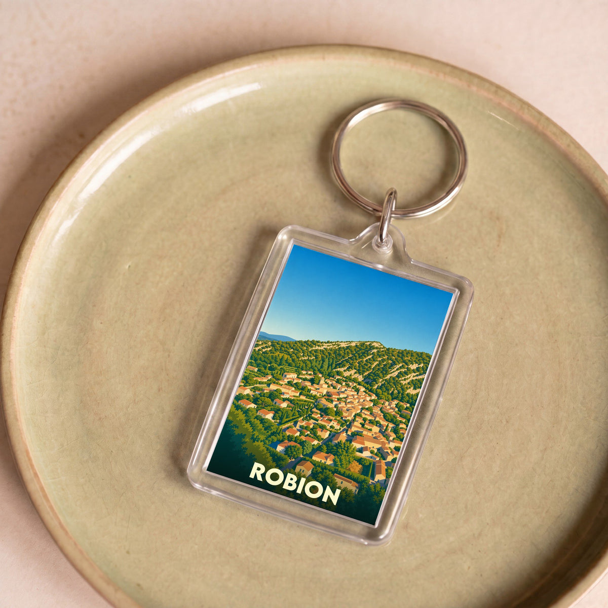 Porte-clés souvenir de la ville de Robion avec une illustration stylisée.