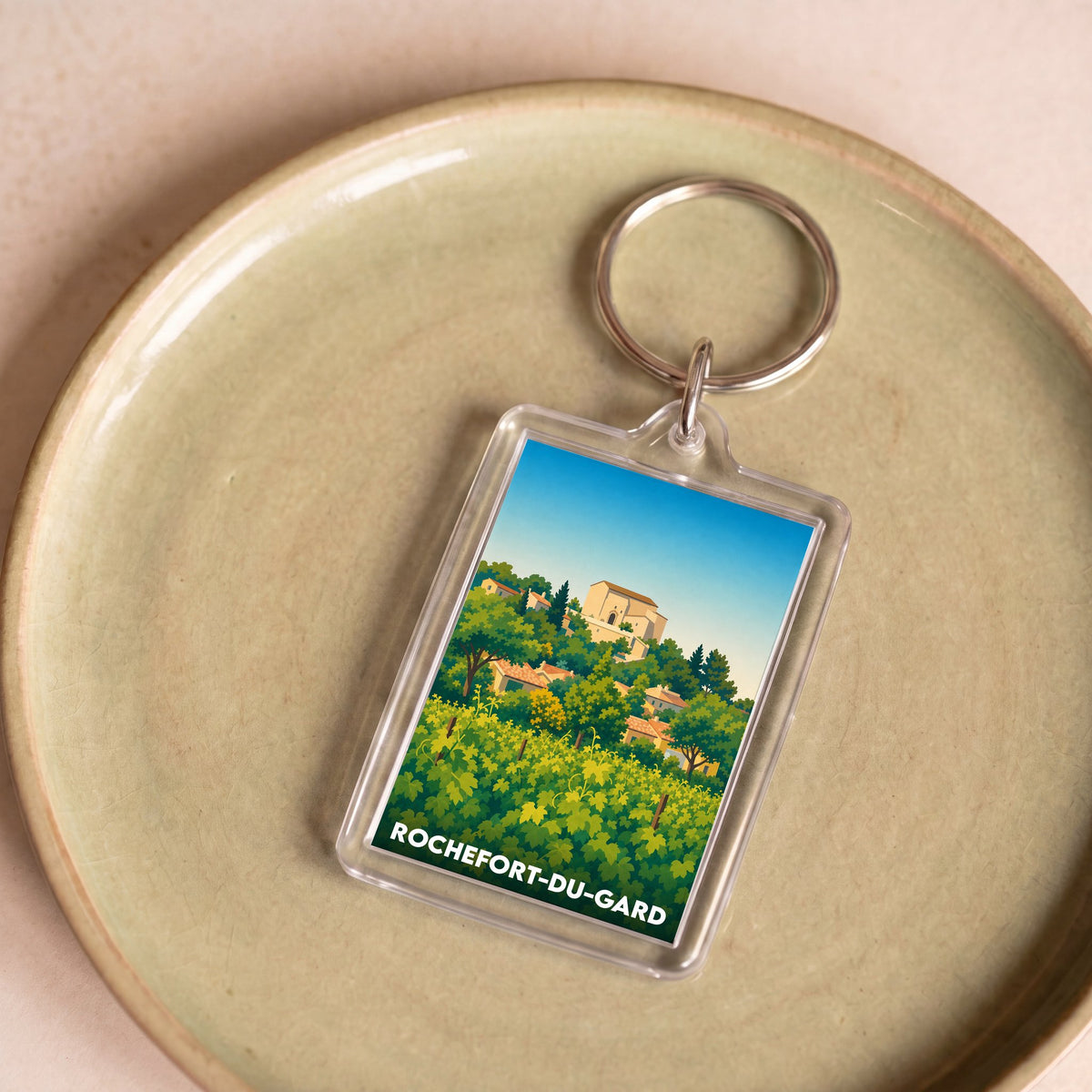 Porte-clés souvenir de la ville de Rochefort-du-Gard avec une illustration stylisée.