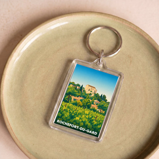 Porte-clés souvenir de la ville de Rochefort-du-Gard avec une illustration stylisée.