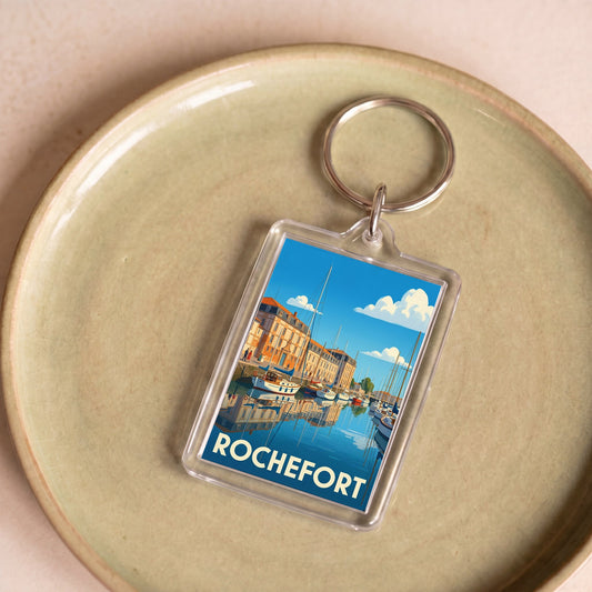 Porte-clés souvenir de la ville de Rochefort avec une illustration stylisée.