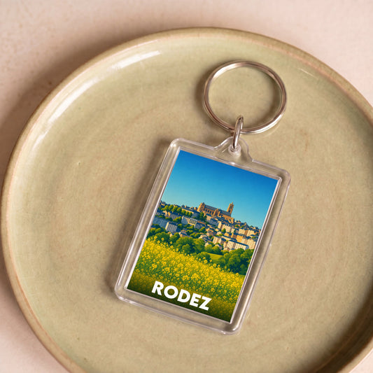 Porte-clés souvenir de la ville de Rodez avec une illustration panoramique stylisée.