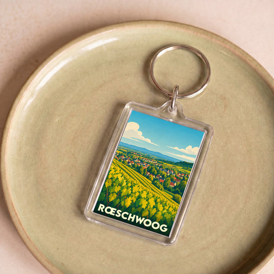 Porte-clés souvenir de la ville de Rœschwoog avec une illustration stylisée de vignobles.