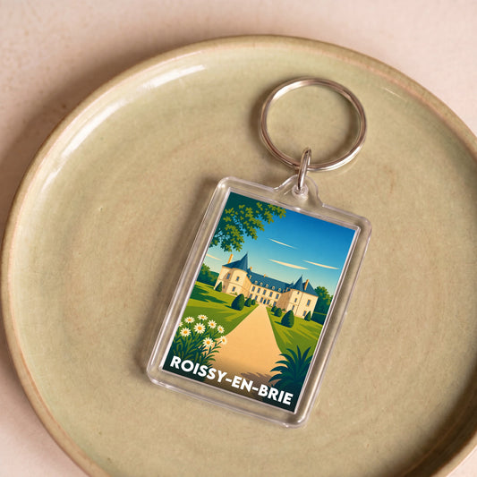 Porte-clés souvenir de la ville de Roissy-en-Brie avec une illustration stylisée.
