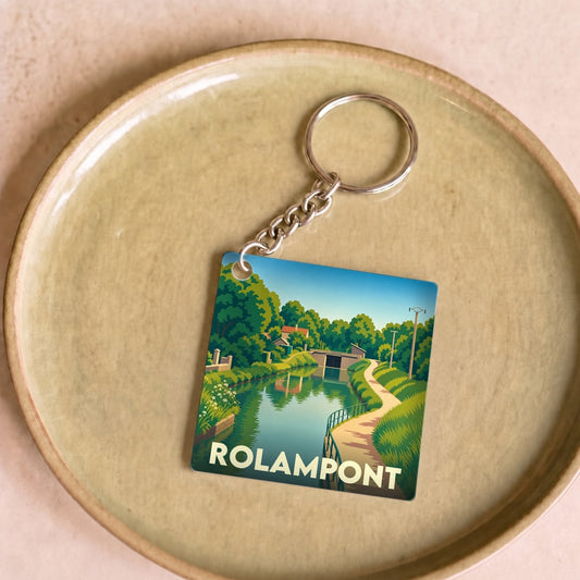 Porte-clés souvenir de la ville de Rolampont avec une illustration stylisée d'un canal.