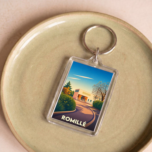 Porte-clés souvenir de la ville de Romillé avec une illustration stylisée et colorée.