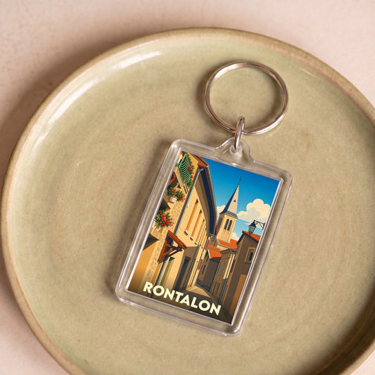 Porte-clés souvenir de la ville de Rontalon avec une illustration stylisée de ses rues et de son clocher.