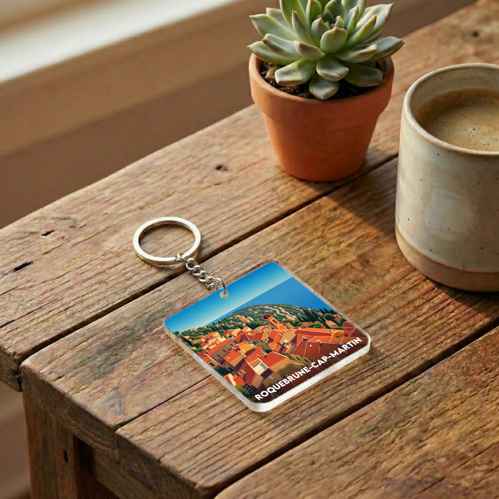 Porte-clés souvenir de la ville de Roquebrune-Cap-Martin avec une illustration stylisée.