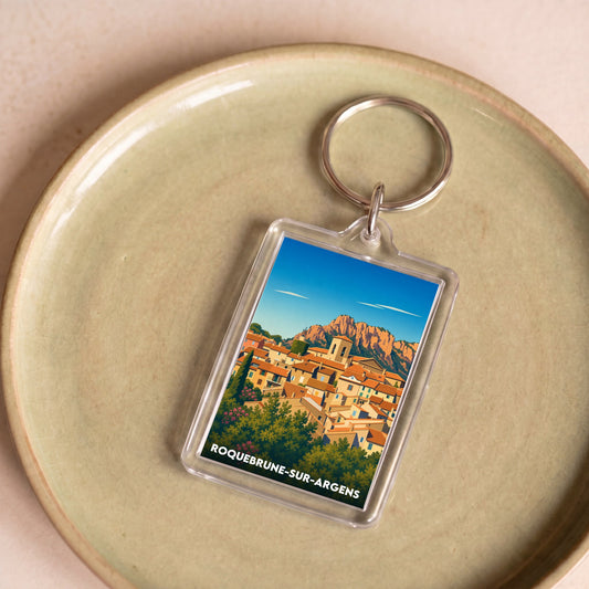 Porte-clés souvenir de la ville de Roquebrune-sur-Argens avec une illustration stylisée.