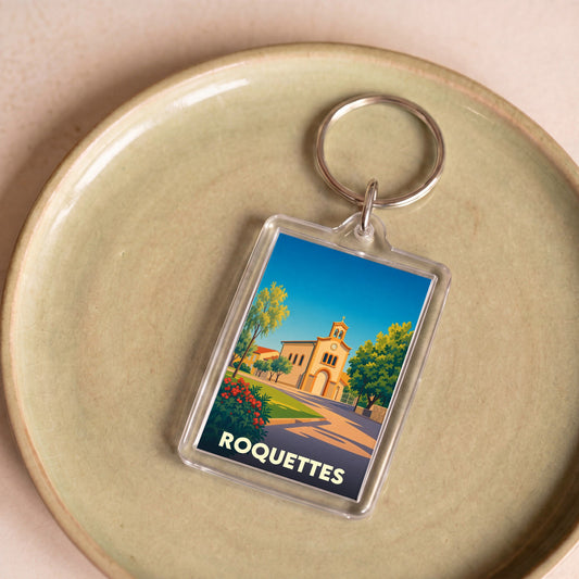 Porte-clés souvenir de la ville de Roquettes avec une illustration stylisée.