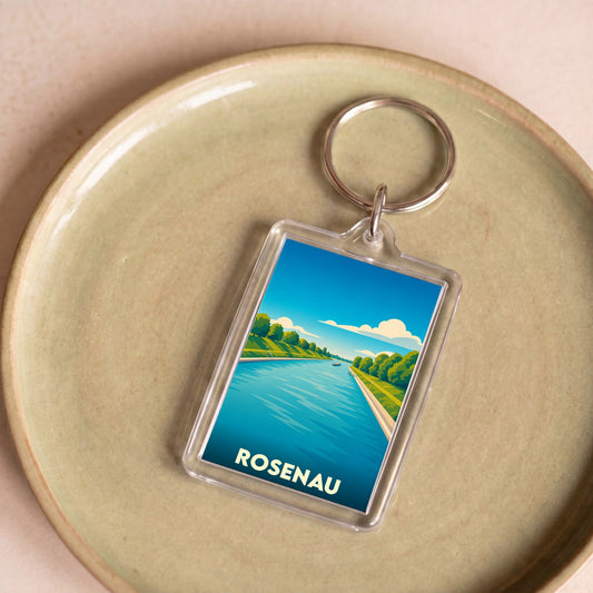 Porte-clés souvenir de la ville de Rosenau avec une illustration stylisée d'un cours d'eau bordé d'arbres.