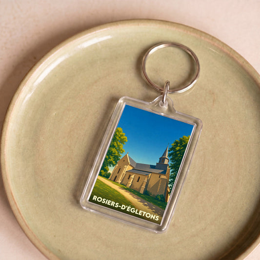 Porte-clés souvenir de la ville de Rosiers-d'Égletons avec une illustration stylisée de son église.