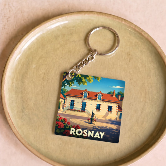 Porte-clés souvenir de la ville de Rosnay avec une illustration stylisée d'une maison berrichonne.