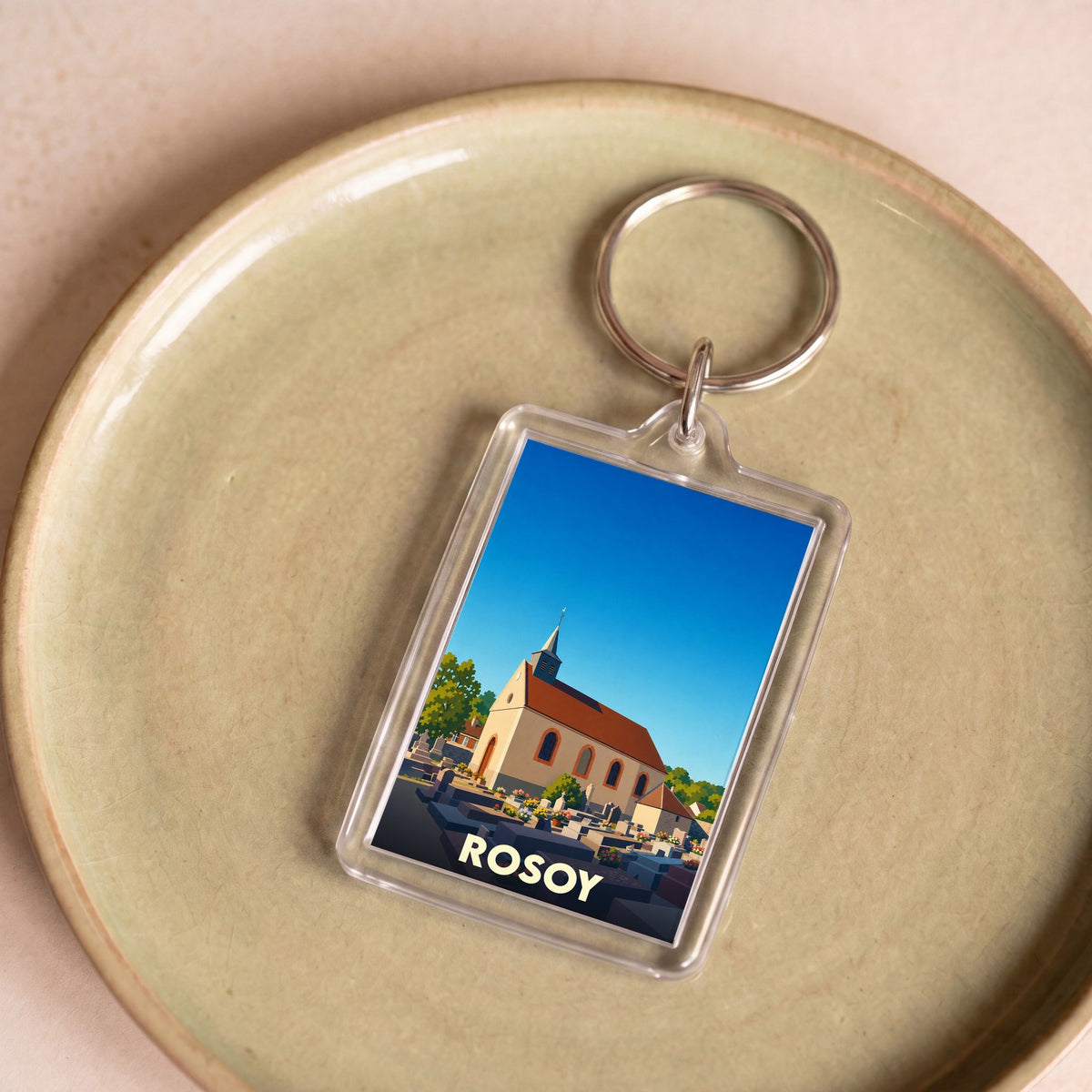 Porte-clés souvenir de la ville de Rosoy avec une illustration stylisée de son église.