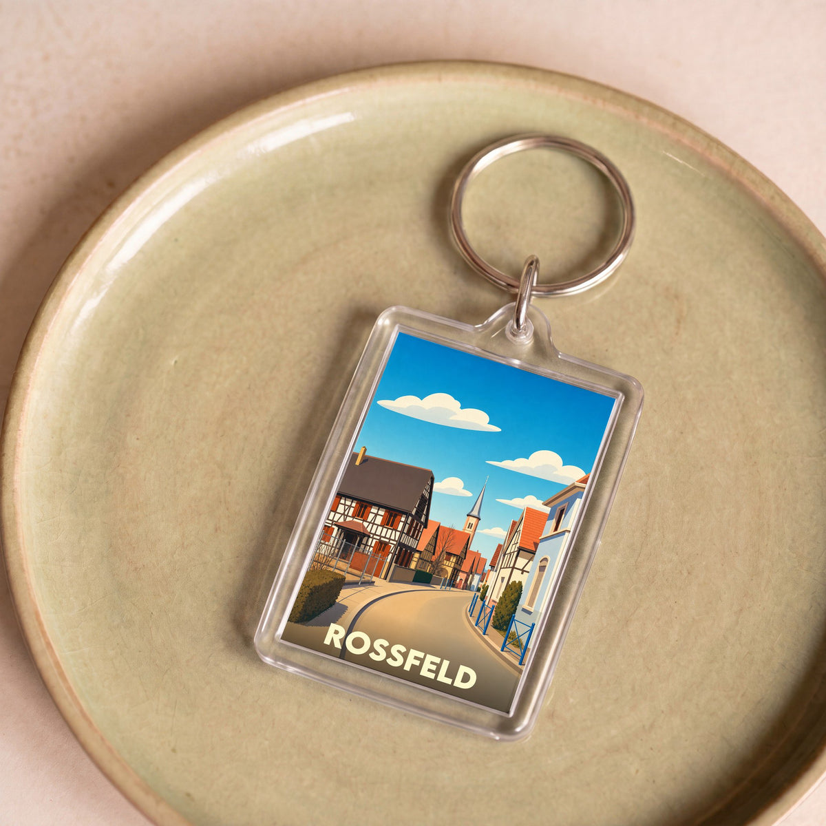 Porte-clés souvenir de la ville de Rossfeld avec une illustration stylisée.