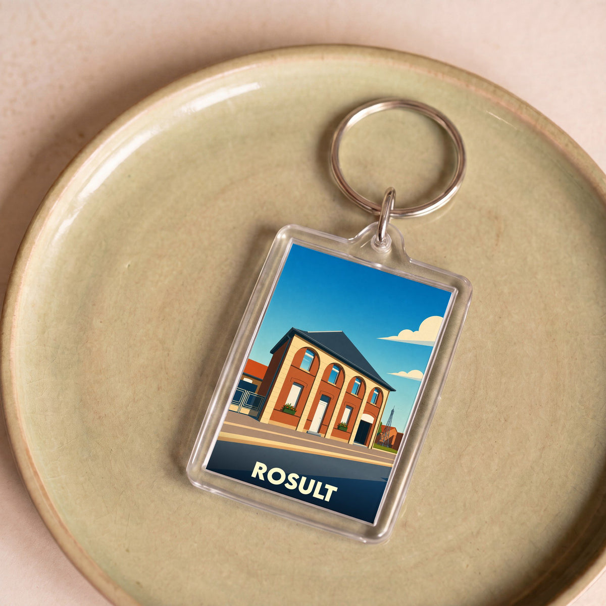 Porte-clés souvenir de la ville de Rosult avec une illustration stylisée de sa mairie.
